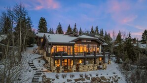 A large, multi-story lodge with a stone foundation, multiple balconies, and a snow-covered landscape. - Abode at Mountains Edge, ski-in/ski-out, hot tub, pool table (Park City)