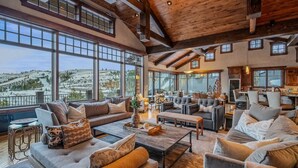 A spacious living area with large windows, a wooden ceiling, and modern furniture. - Abode at Mountains Edge, ski-in/ski-out, hot tub, pool table (Park City)