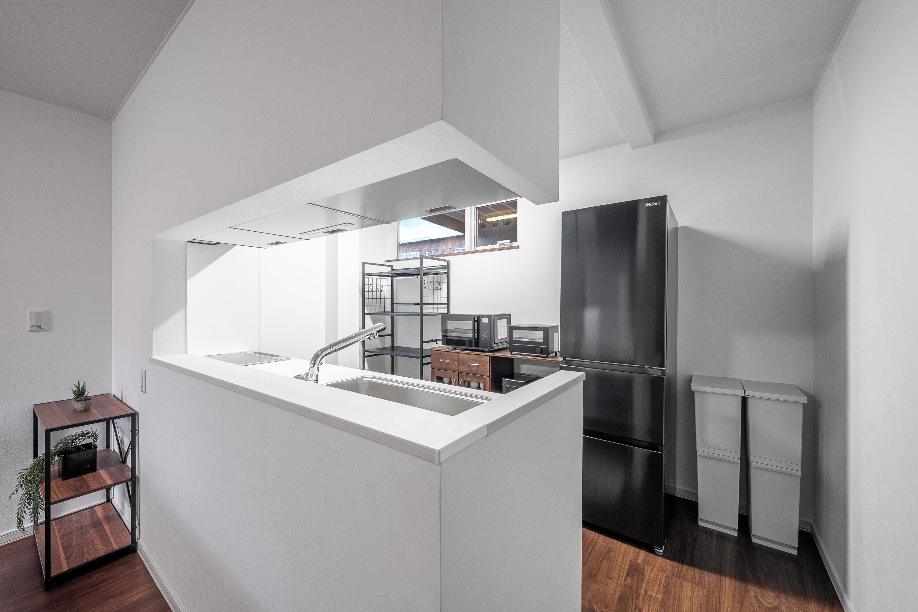 A modern kitchen with a built-in island, stainless steel appliances, and a minimalist design.