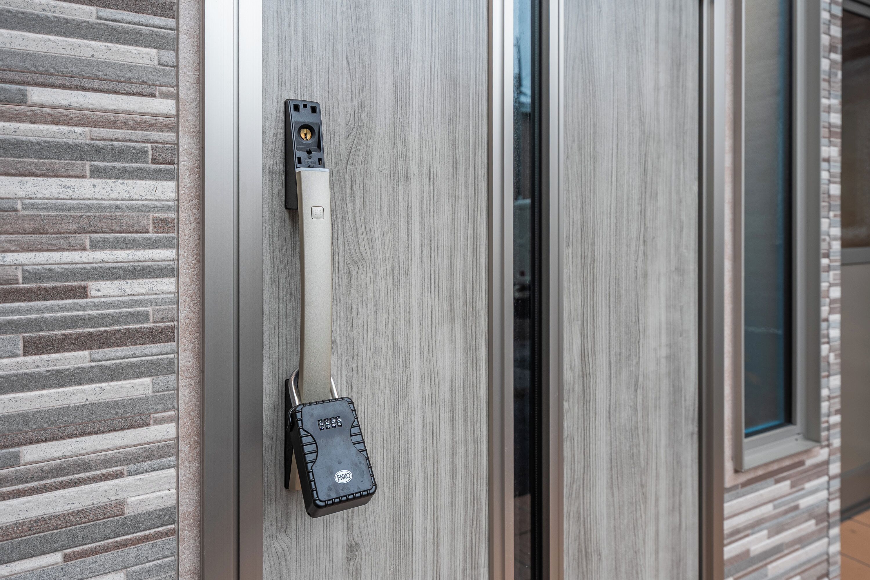 A door with a security device, a textured wall, and a window.