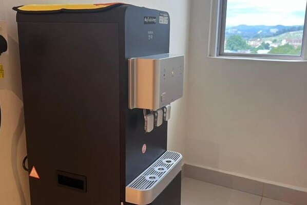 A water dispenser with a control panel and a window view. - Swing & Pillows @ Kajang Selangor (Kajang)