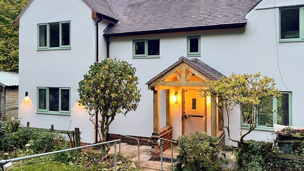 A two-story house with a small porch and a staircase leading to the entrance. - 3 bedroom accommodation in Brereton, Cannock Chase (Brereton, Cannock Chase)