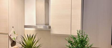 Departamento Confort, vista parcial al mar | Cocina privada | Refrigerador, microondas, horno y parrilla de estufa