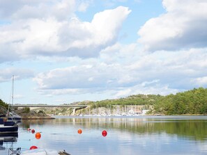 A calm lake with boats, buoys, and a bridge in the background. - 4 Star Holiday Home in Uddevalla (Uddevalla)