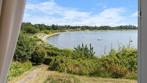 A view of a lake with boats, a path, and greenery. - "Rajna" - 30m from the sea by Interhome (Martofte)