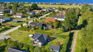 An aerial view of a residential area with houses, a clear sky, and a view of the sea. - "Allin" - 350m from the sea by Interhome (Otterup)