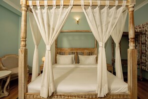A four-poster canopy bed with white linens and a wooden headboard. - Ramat Niwas by Kutani Stays (Jaipur)