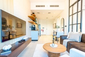 A modern hotel lobby with a seating area, a kitchen, and a large window. - Steps from Dubai Hills Mall, Near Scenic Park, and Easily Connected to Dubai’s Top Attractions (Dubai)