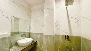 A bathroom with a white sink, a mirror, and a shower area with a green and white marble wall. - HOTEL PREMIUM K P  Near HAR KI PODDI   (Haridwar)