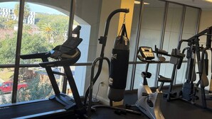 A gym with cardio machines, a punching bag, and a rowing machine. - Walk to FSU, Downtown & the Capitol-PRIME location (Tallahassee)