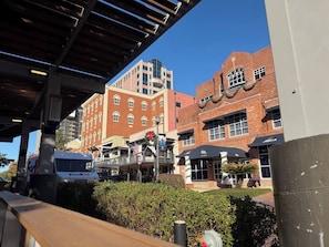 A commercial area with brick buildings, a FedEx truck, and a sign with a wreath. - Walk to FSU, Downtown & the Capitol-PRIME location (Tallahassee)