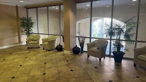 A spacious lobby with beige walls, large windows, and several beige armchairs. - Walk to FSU, Downtown & the Capitol-PRIME location (Tallahassee)