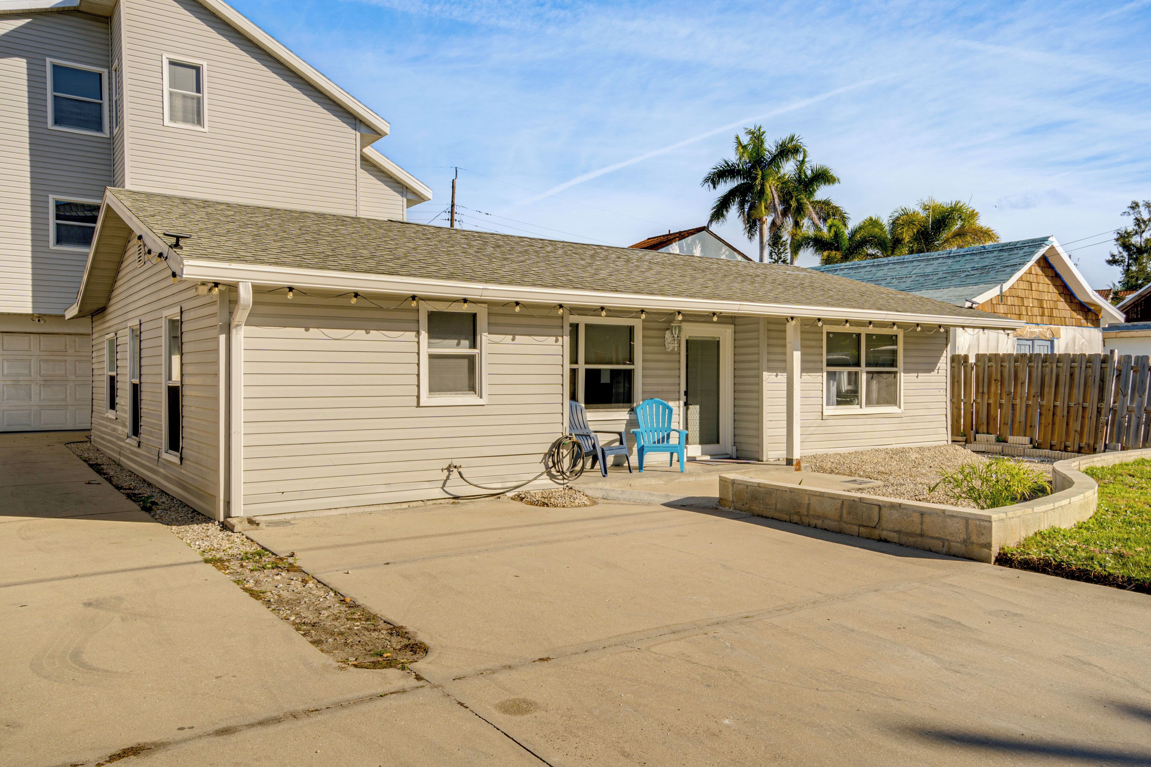A single-story house with a front porch, a small garden, and a wheelchair accessible ramp.