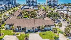 A modern hotel with a large central building, multiple smaller structures, and a well-maintained lawn. - 650 Feet to the Beach! Arcadian Shores Townhome (Myrtle Beach)