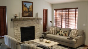 A living room with a fireplace, a sofa set, and a coffee table. - Beautifully Remodeled Townhome on Peak 8 (Breckenridge)