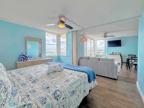 A hotel room with a bed, a desk, a sofa, and a TV. - Estero Beach & Tennis Club #801C Beachfront Condo (Fort Myers Beach)
