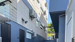 A narrow, multi-level outdoor corridor with concrete steps and metal railings, leading to a building entrance. - Seafront Studio C4 (Simpson Bay)