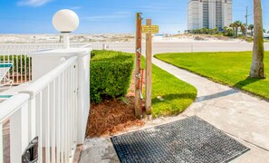 A gated entrance with a security camera, a metal detector, and a sign indicating a private beach access. - Grand Beach Resort Condos (Gulf Shores)