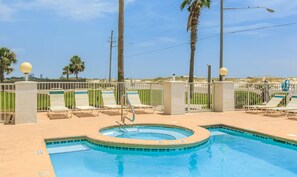 A pool area with lounge chairs and a hot tub. - Grand Beach Resort Condos (Gulf Shores)