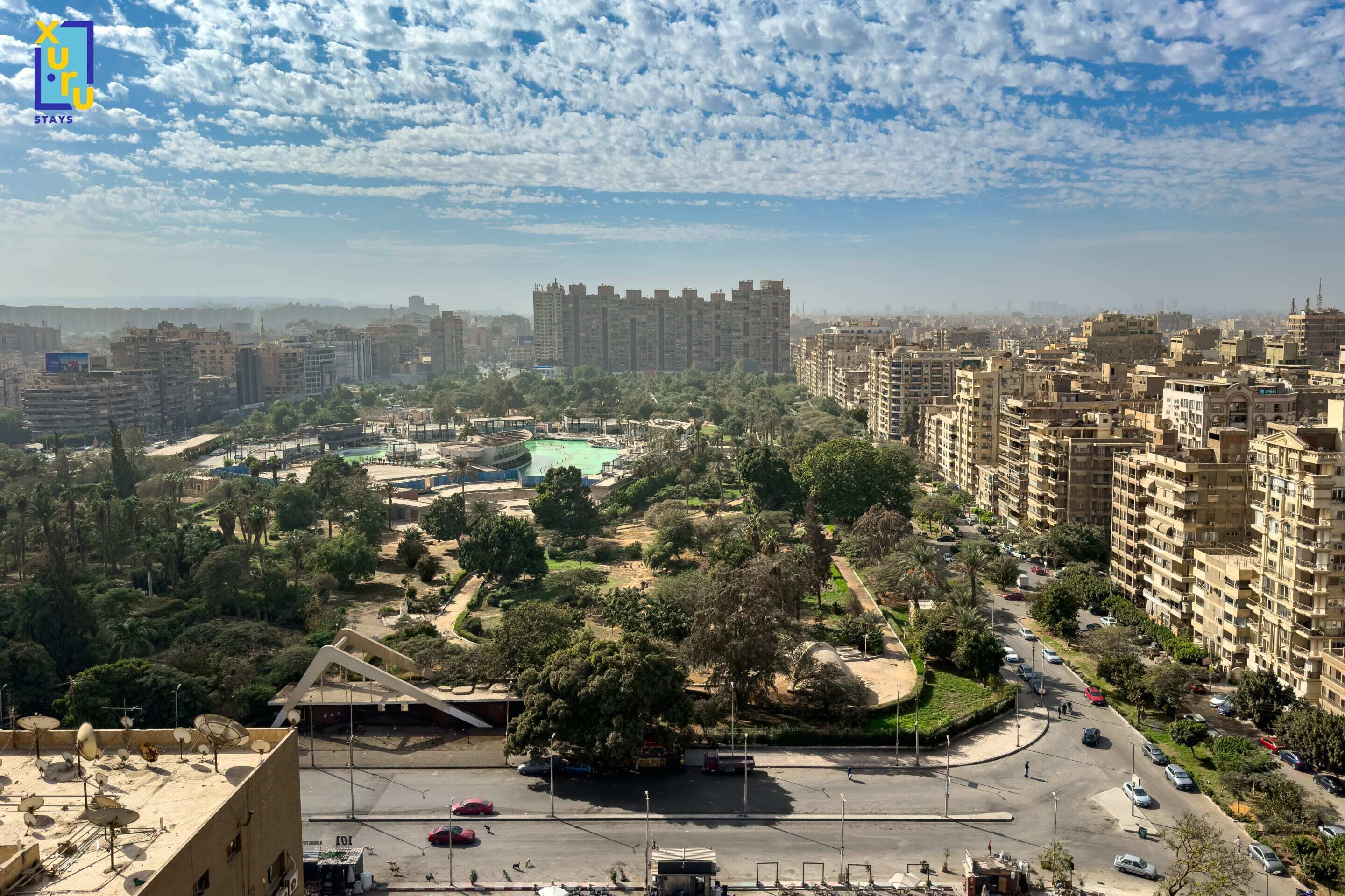 A cityscape with high-rise buildings, a roundabout, and a park area.