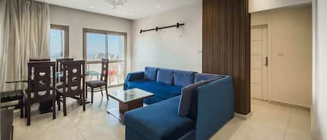 Basic Apartment | Living area | 55-inch TV with satellite channels