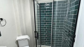 Deluxe Studio | Bathroom | Shower, hair dryer, towels, soap