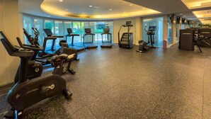 A gym with various exercise equipment, including treadmills, stationary bikes, and weight machines. - Durrani Homes - Alluring 5BR with Private Jacuzzi (Dubai)