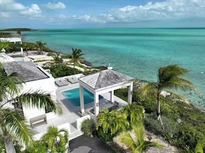 A resort with a pool, a gazebo, and a view of the ocean. - Oceanfront Luxury Villa with Turquoise Views Private Beachfront Retreat (Long Bay Hills)