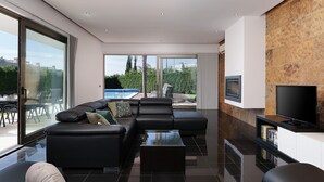 Ein modernes Wohnzimmer mit einer Eckcouch, einem Couchtisch und einem Flachbildfernseher.