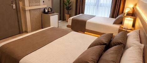 Family Triple Room, City View | Premium bedding, minibar, free WiFi, bed sheets