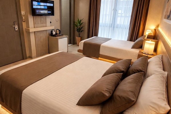Family Triple Room, City View | Premium bedding, minibar, soundproofing, free WiFi