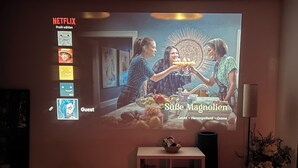 A projection screen displaying a movie scene with a group of people. - Cozy in the old town and nature (Trier)