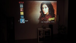 A projection of a movie poster for 'Brooklyn Nine-Nine' on a wall in a dimly lit room. - Cozy in the old town and nature (Trier)