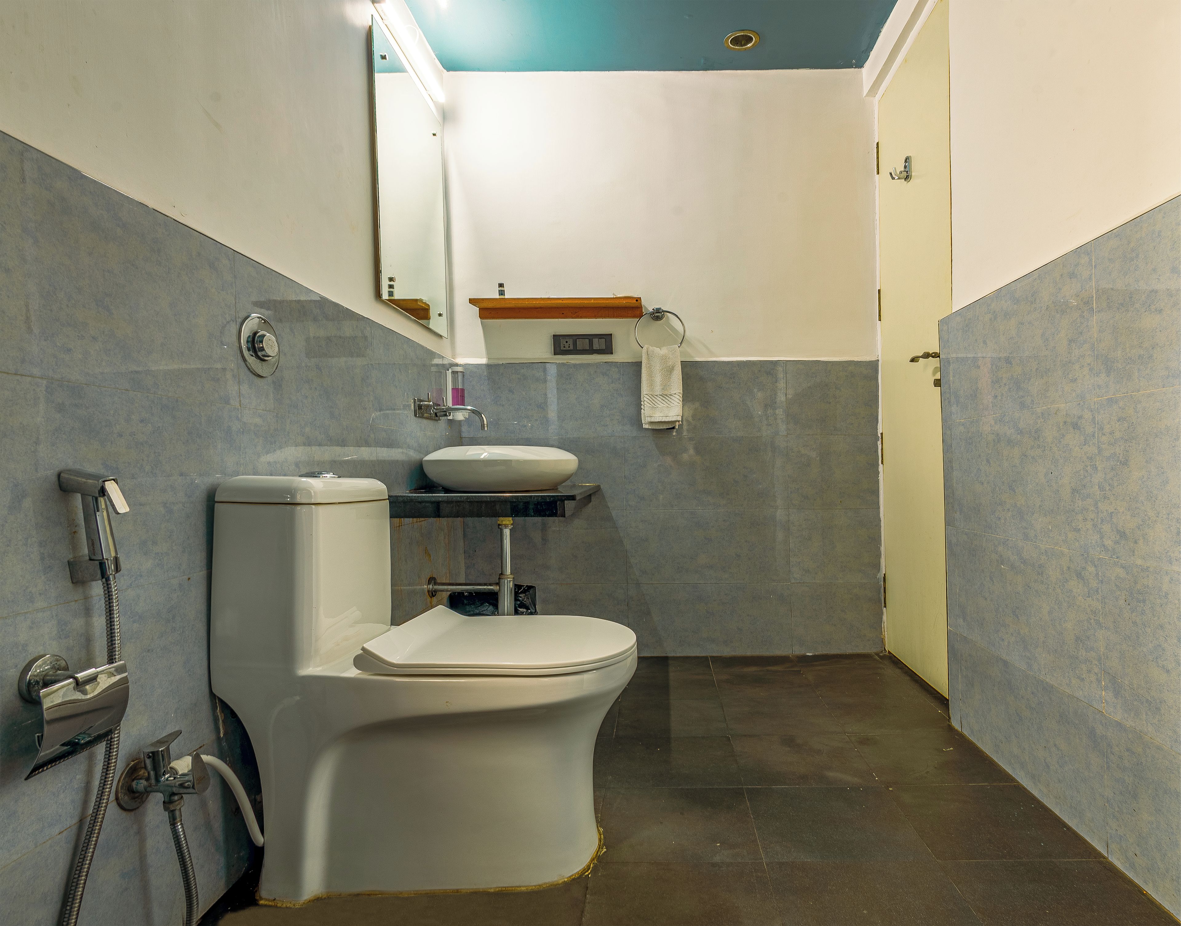A bathroom with a toilet, sink, and shower.