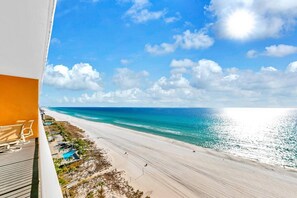A balcony with a view of a beach and ocean. - Seaside Serenity/Corner Unit/Best Gulf View (Panama City Beach)