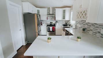 Fridge, microwave, coffee/tea maker, cookware/dishes/utensils
