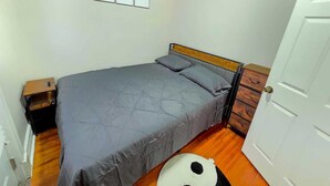 A small bedroom with a bed, a bedside table, a wall with three framed inspirational quotes, and a door. - Your favorite space (Schenectady)