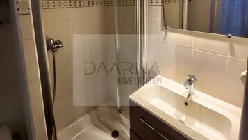 Shower, hair dryer, soap, toilet paper