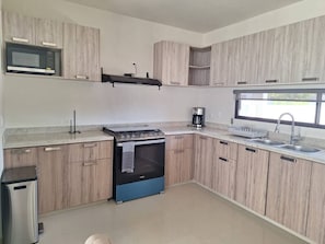 Fridge, coffee/tea maker, cookware/dishes/utensils
