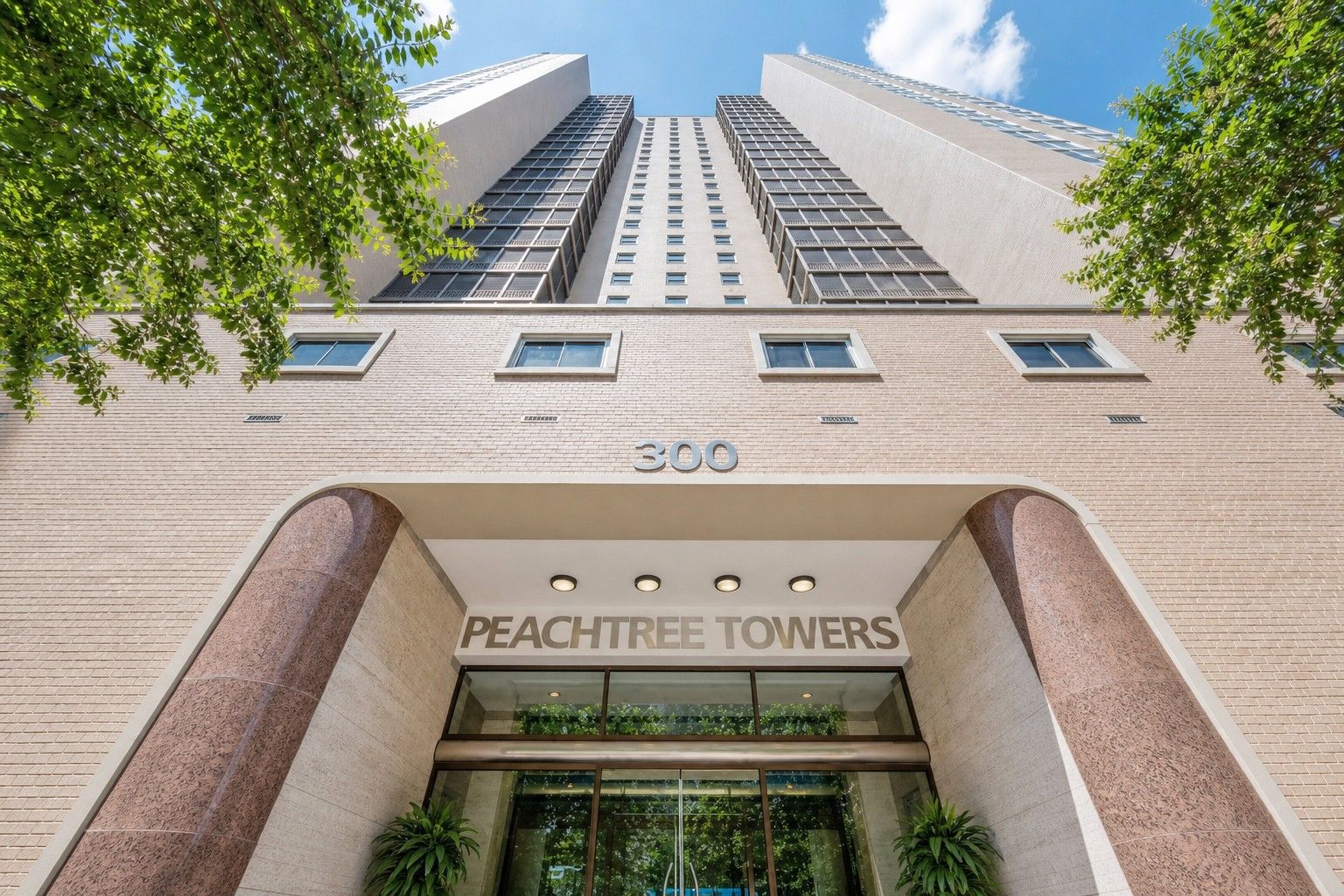 A building with a prominent entrance labeled '300 PEACHTREE TOWERS' and a large number '300' on the facade.