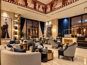 A spacious living room with a large sofa set, a coffee table, and a fireplace. - Luxury 2BR |Burj View|Fully equipped|Top-Amenities (Dubai)