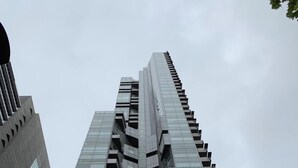 A high-rise building with a modern architectural design, featuring a series of balconies and reflective glass windows. - Spacious landmark in the heart of Mel CBD (Melbourne)