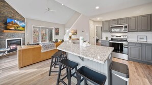 A modern kitchen with granite countertops, a built-in oven, and a microwave. - Cozy Cottage in Yonahlossee Racquet Club (Boone)
