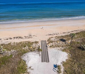 A beach with a paved walkway leading to the shore. - Boaters Dream Pool Spa Dock Walking Biking (Palm Coast)