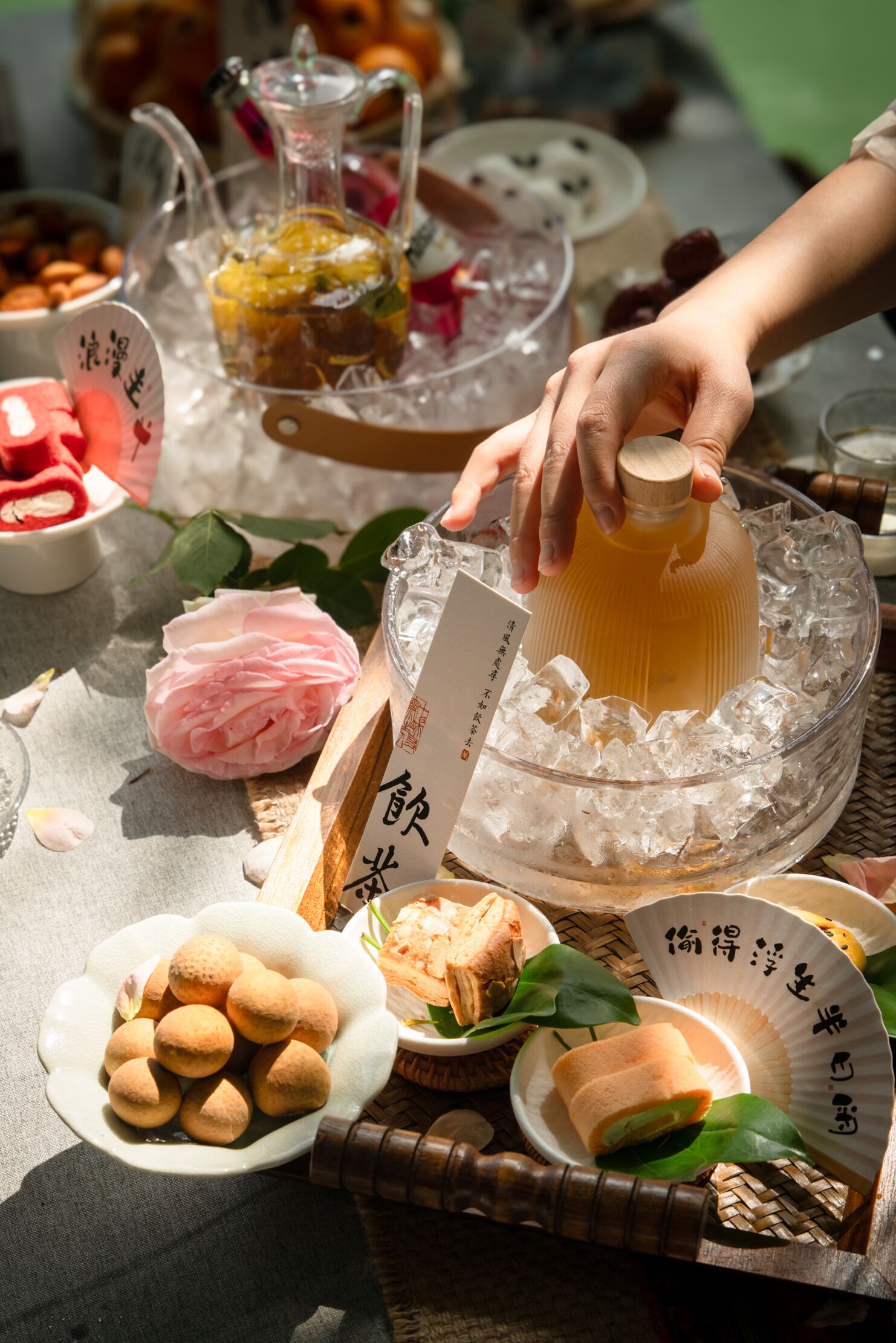 A table with a pitcher, plates of food, and a bowl of ice.