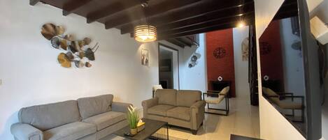 A living room with two sofas, a coffee table, and a fireplace.