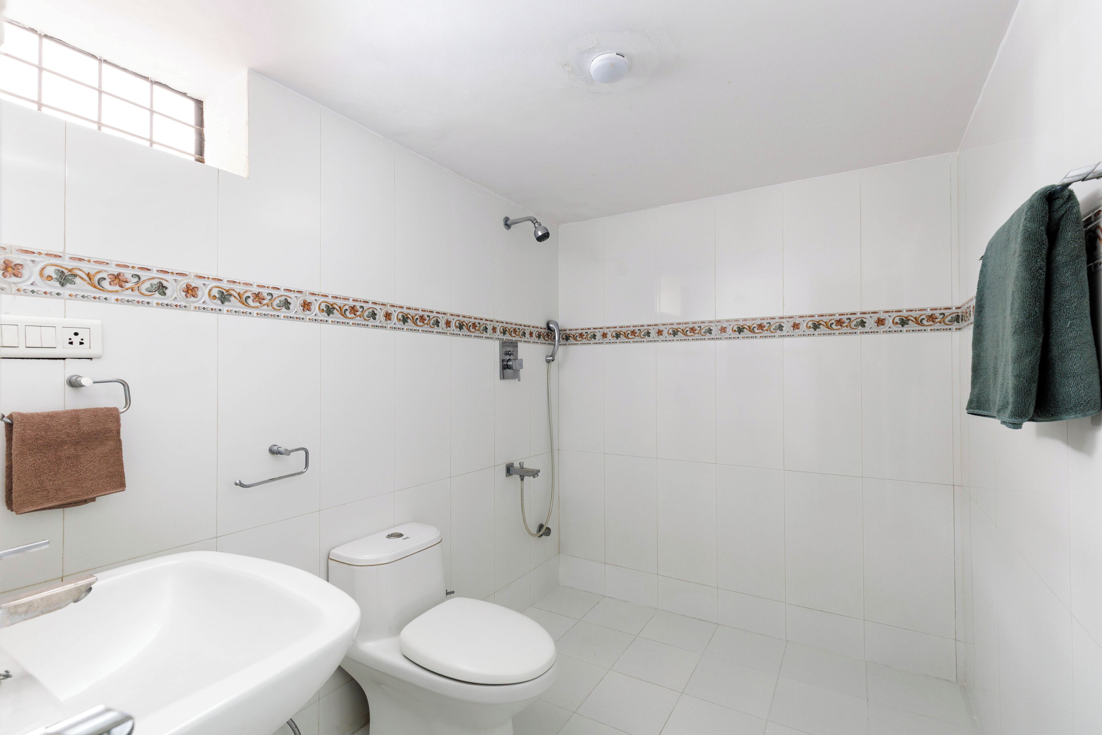 A bathroom with a bathtub, toilet, and shower.