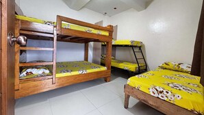 A dormitory room with bunk beds, a wooden door, and a tiled floor. - OYO 1190 Manzel Shanicaye Private Villa (Calamba)