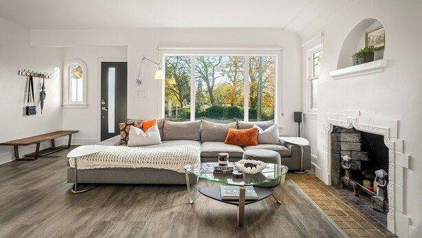 A modern living room with a large window, a fireplace, and a cozy seating area. - NFL Spacious Green Lake Home, Dog OK, BBQ/Karaoke (Seattle)