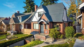 A residential house with a brick exterior, a sloped roof, and a front porch. - NFL Spacious Green Lake Home, Dog OK, BBQ/Karaoke (Seattle)